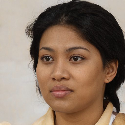 Neutral latino young-adult female with medium  brown hair and brown eyes