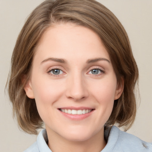 Joyful white young-adult female with medium  brown hair and blue eyes