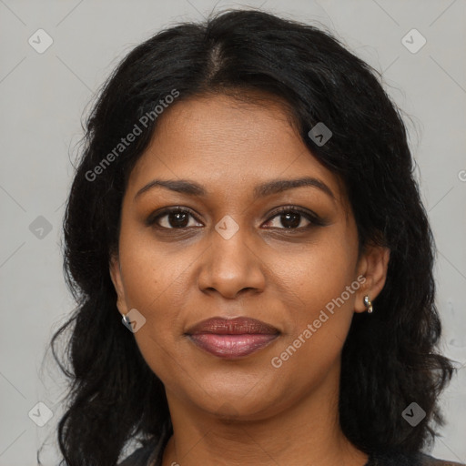 Joyful black young-adult female with long  brown hair and brown eyes