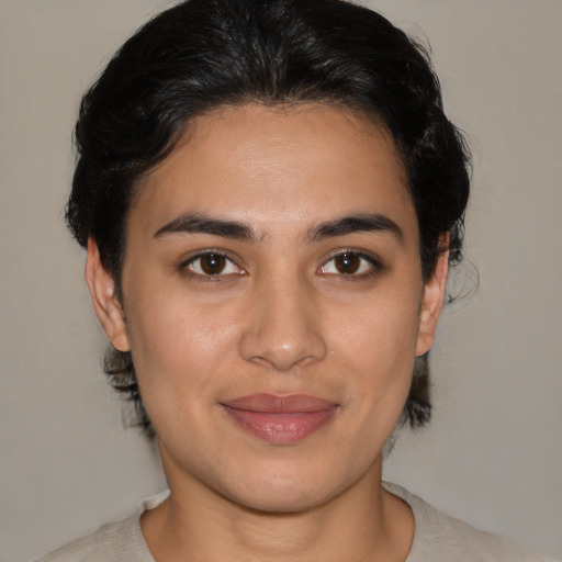 Joyful latino young-adult female with medium  brown hair and brown eyes