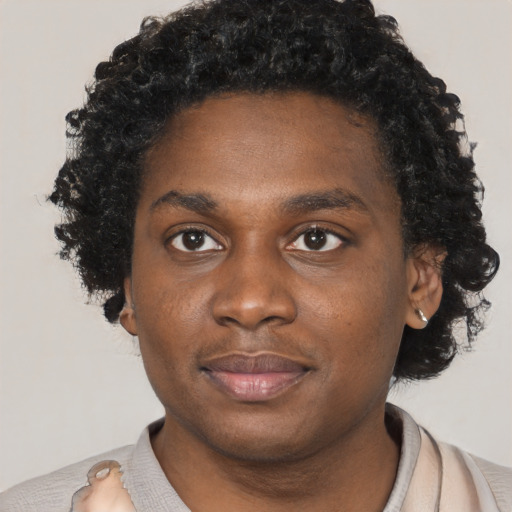 Joyful black young-adult male with short  brown hair and brown eyes