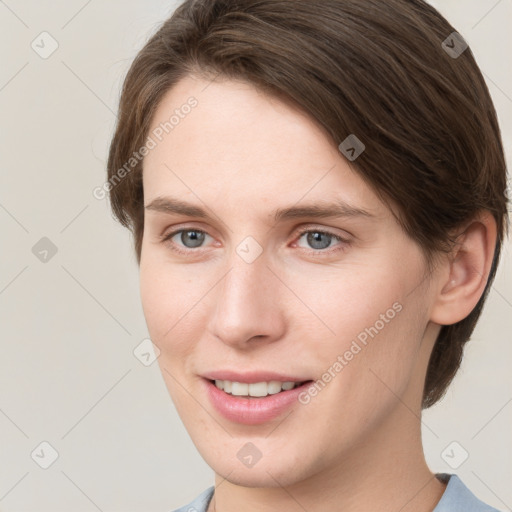 Joyful white young-adult female with short  brown hair and grey eyes