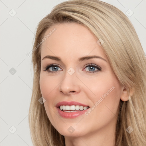 Joyful white young-adult female with long  brown hair and blue eyes