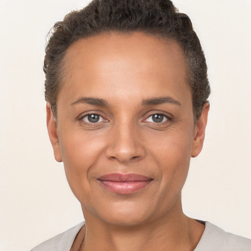 Joyful white adult female with short  brown hair and brown eyes