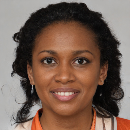 Joyful black young-adult female with medium  brown hair and brown eyes