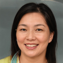 Joyful white adult female with medium  brown hair and brown eyes