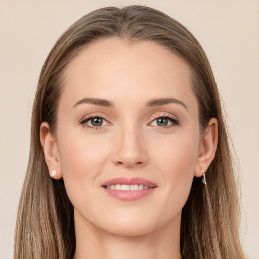 Joyful white young-adult female with long  brown hair and brown eyes