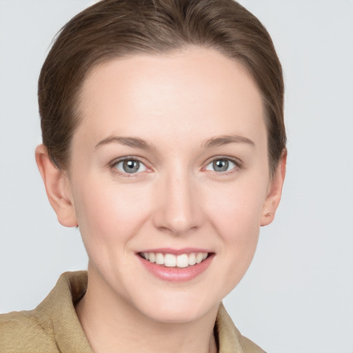 Joyful white young-adult female with short  brown hair and grey eyes