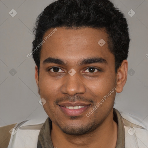 Joyful black young-adult male with short  black hair and brown eyes