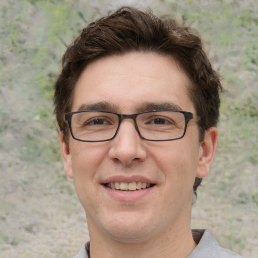 Joyful white young-adult male with short  brown hair and green eyes