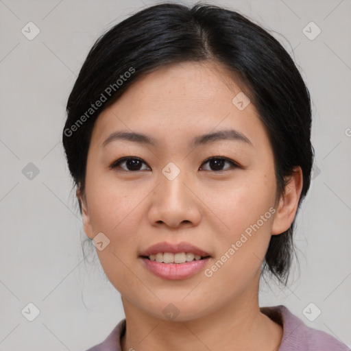 Joyful asian young-adult female with medium  black hair and brown eyes