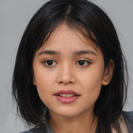 Joyful asian young-adult female with medium  black hair and brown eyes