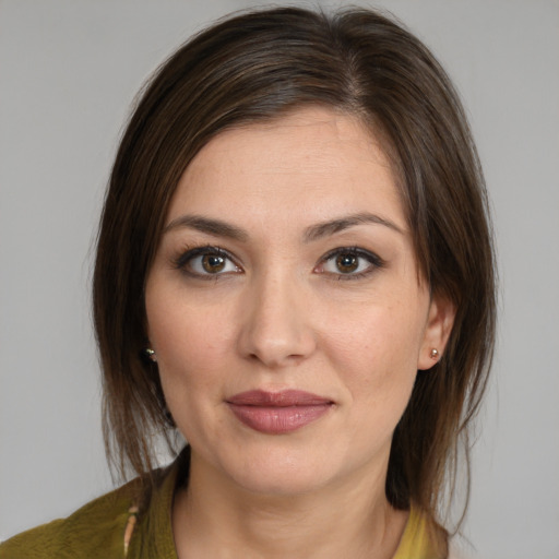 Joyful white young-adult female with medium  brown hair and brown eyes