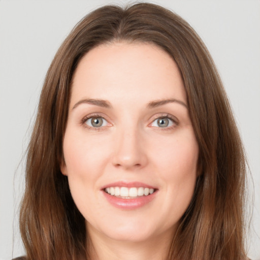 Joyful white young-adult female with long  brown hair and grey eyes