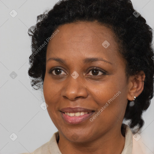 Joyful black adult female with short  brown hair and brown eyes