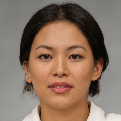 Joyful asian adult female with medium  brown hair and brown eyes