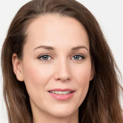 Joyful white young-adult female with long  brown hair and grey eyes