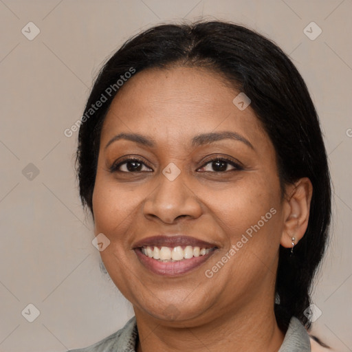 Joyful latino adult female with medium  brown hair and brown eyes