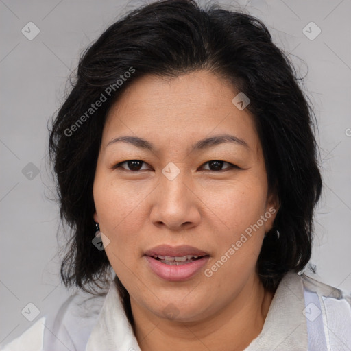 Joyful asian adult female with medium  brown hair and brown eyes