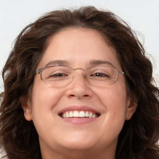 Joyful white adult female with long  brown hair and brown eyes