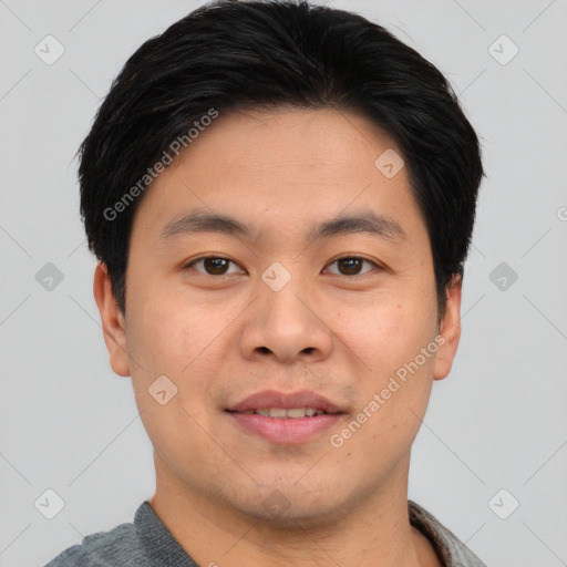 Joyful asian young-adult male with short  black hair and brown eyes