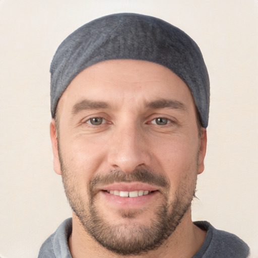 Joyful white young-adult male with short  black hair and brown eyes