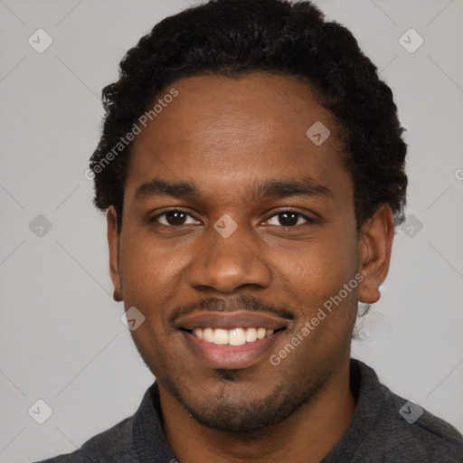 Joyful black young-adult male with short  brown hair and brown eyes