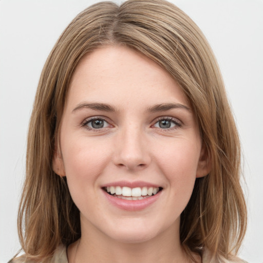 Joyful white young-adult female with medium  brown hair and green eyes