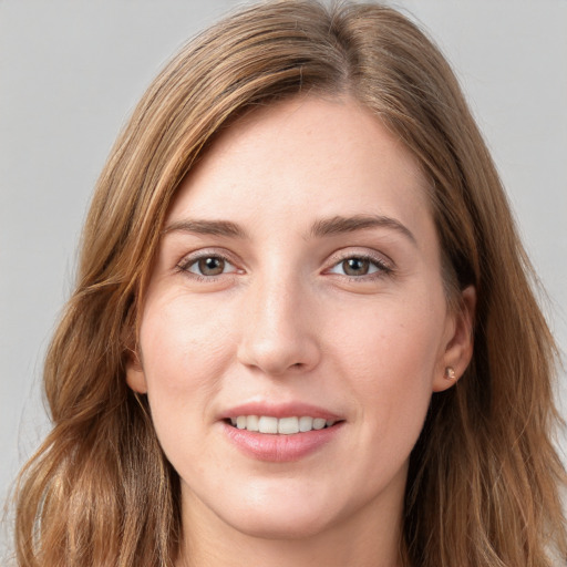 Joyful white young-adult female with long  brown hair and grey eyes