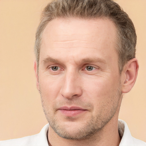 Joyful white adult male with short  brown hair and grey eyes