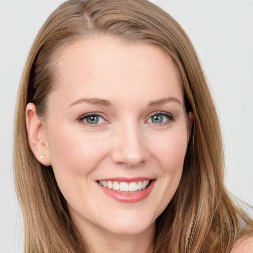 Joyful white young-adult female with long  brown hair and blue eyes