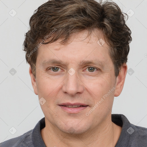 Joyful white adult male with short  brown hair and grey eyes