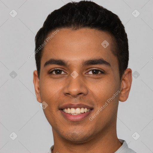 Joyful latino young-adult male with short  black hair and brown eyes