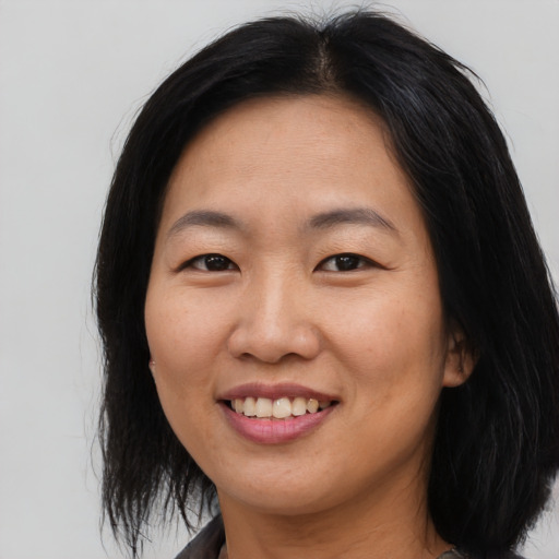 Joyful asian young-adult female with medium  black hair and brown eyes