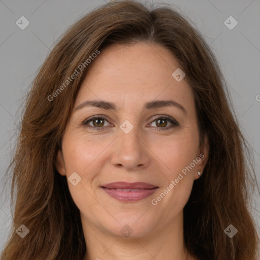 Joyful white adult female with long  brown hair and brown eyes