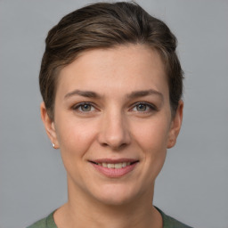 Joyful white young-adult female with short  brown hair and grey eyes