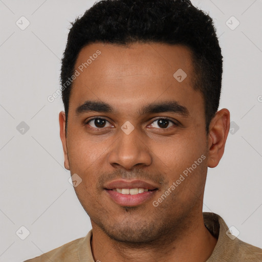 Joyful black young-adult male with short  black hair and brown eyes