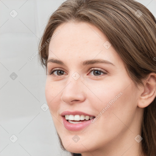 Joyful white young-adult female with long  brown hair and grey eyes