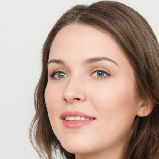 Joyful white young-adult female with long  brown hair and grey eyes