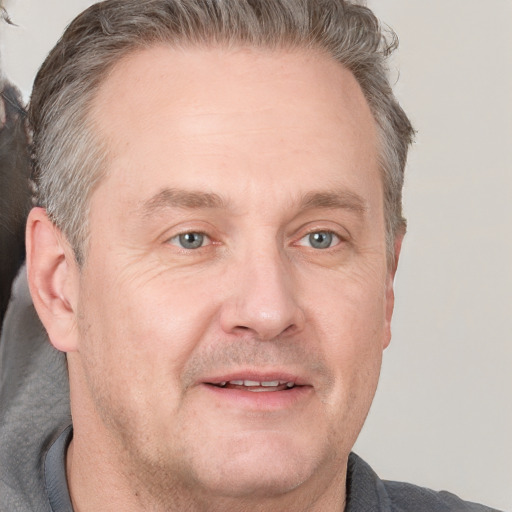 Joyful white adult male with short  brown hair and grey eyes