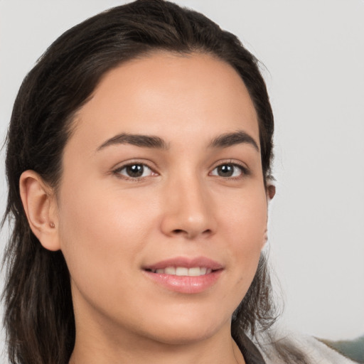 Joyful white young-adult female with long  brown hair and brown eyes