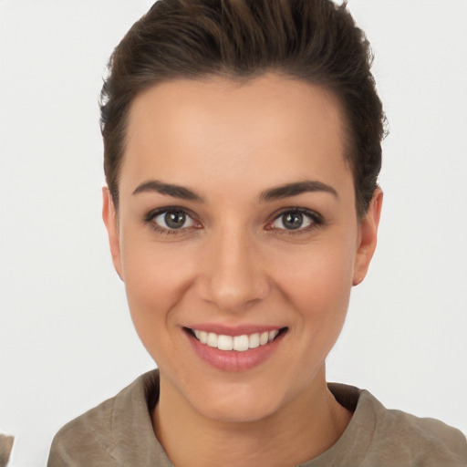 Joyful white young-adult female with short  brown hair and brown eyes