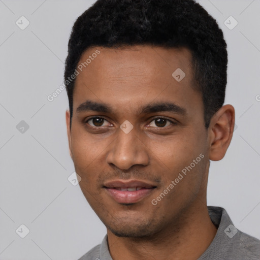 Joyful black young-adult male with short  black hair and brown eyes