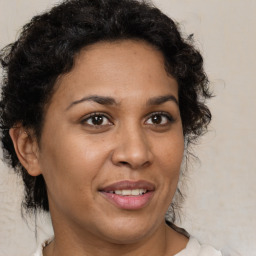 Joyful latino adult female with medium  brown hair and brown eyes