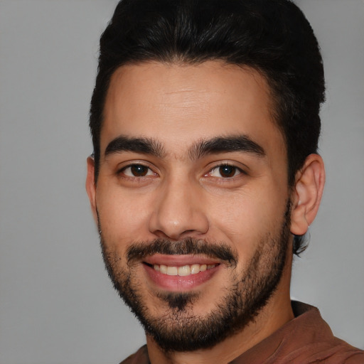 Joyful white young-adult male with short  black hair and brown eyes