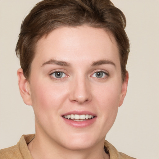 Joyful white young-adult female with short  brown hair and grey eyes