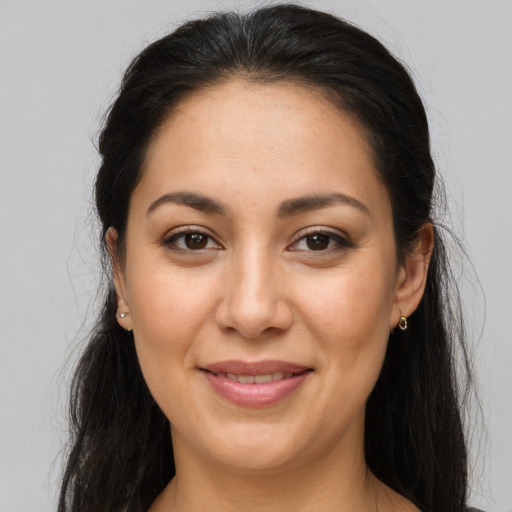 Joyful latino adult female with long  brown hair and brown eyes