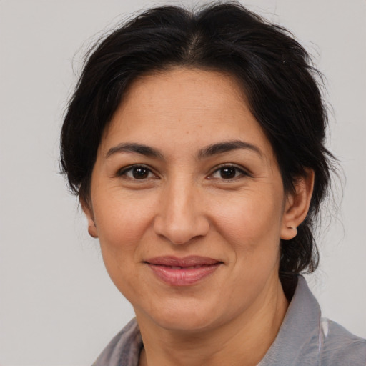 Joyful asian adult female with medium  brown hair and brown eyes