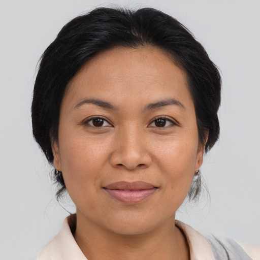 Joyful asian adult female with medium  brown hair and brown eyes
