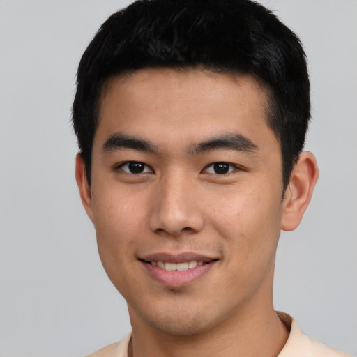 Joyful asian young-adult male with short  black hair and brown eyes